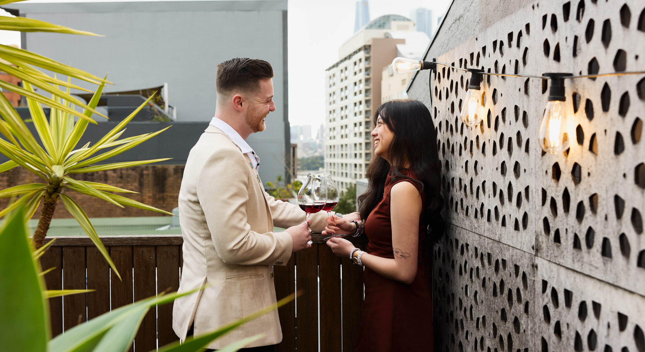 Couple on balcony of Romantic getaway Darling Harbour