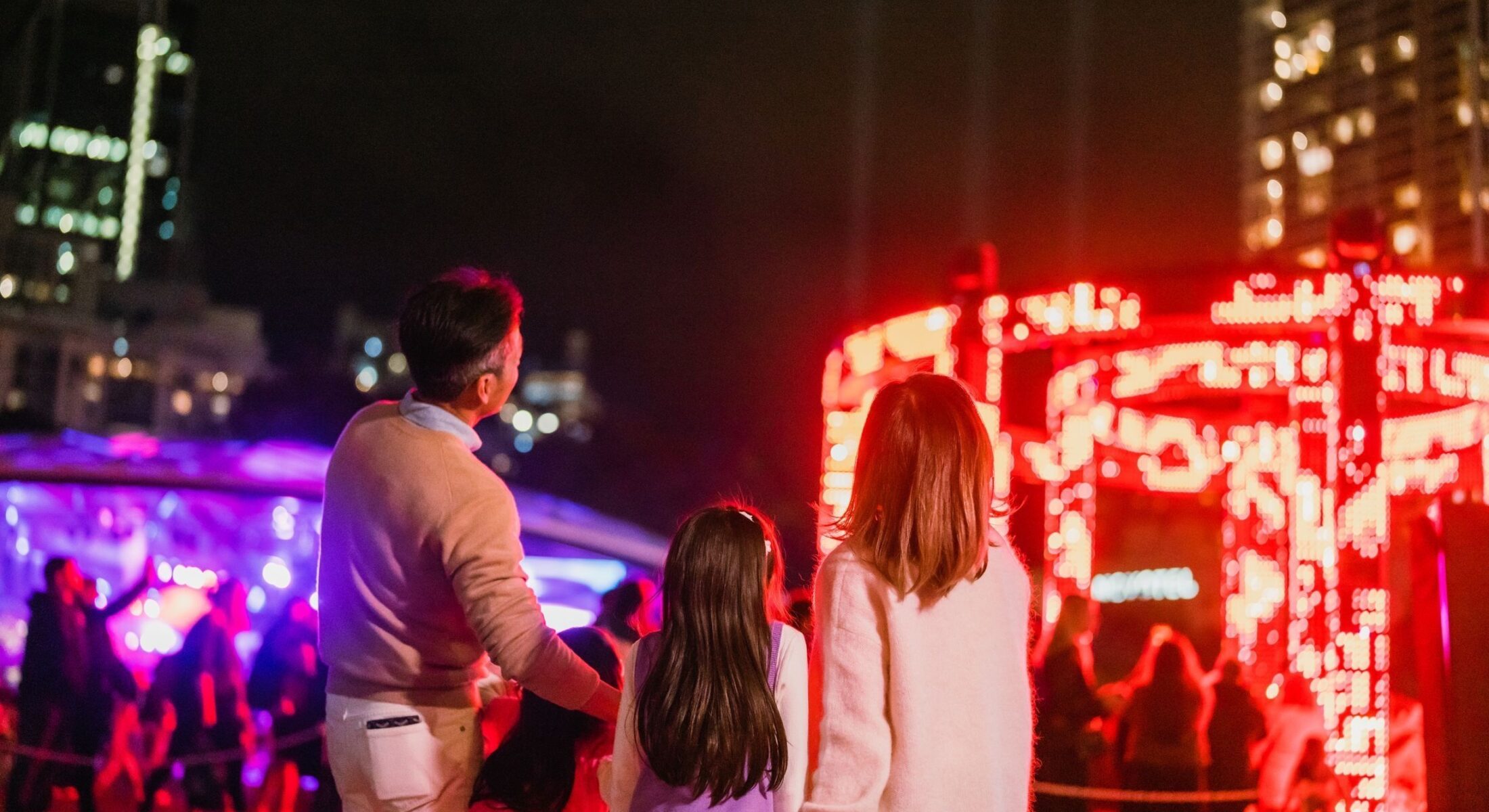 Family enjoying Tumbalong Nights at Tumbalong Park for Vivid Music during Vivid Sydney 2024