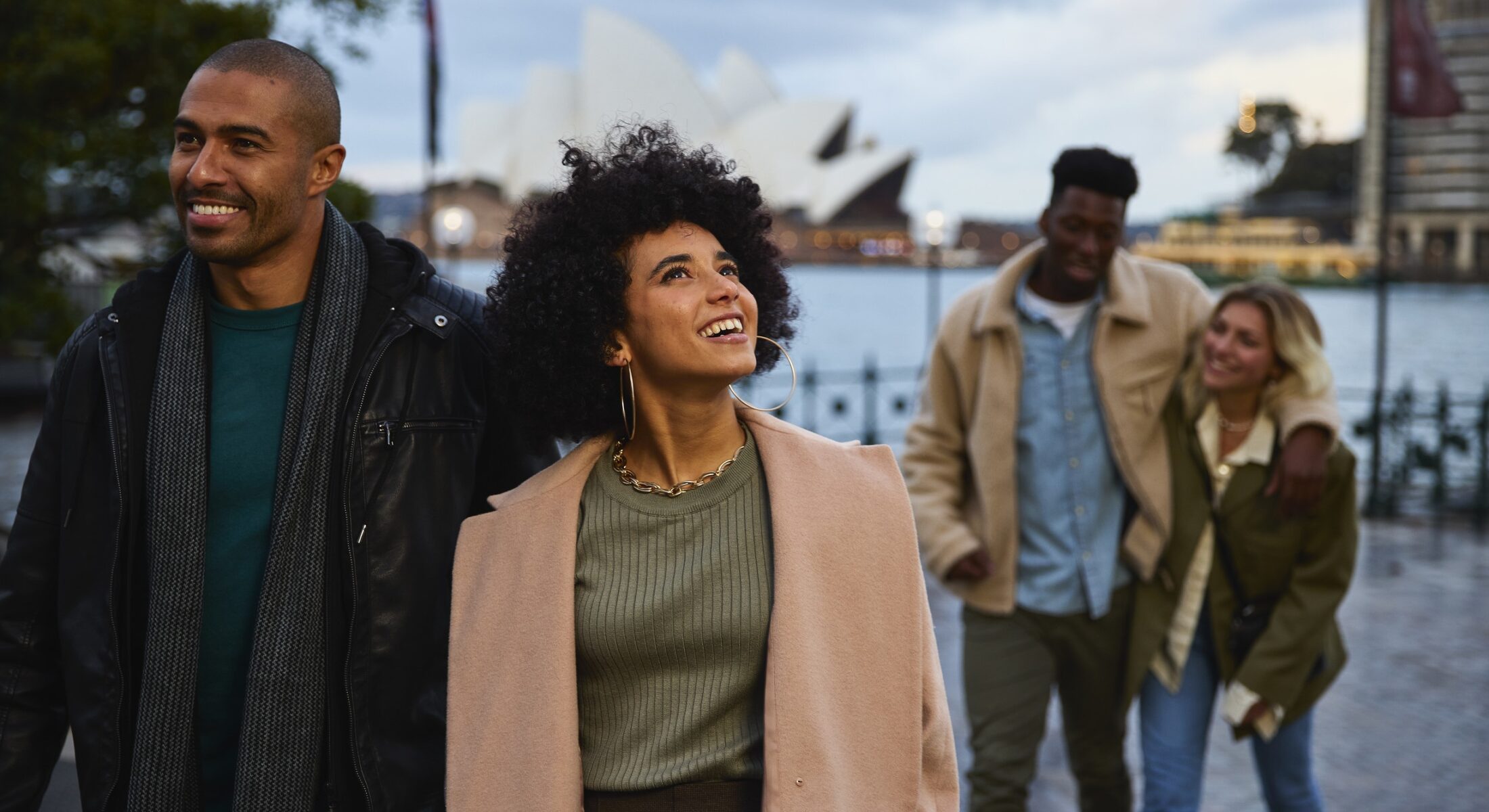 Friends arriving outside the Museum of Contemporary Art Australia in The Rocks, Sydney.